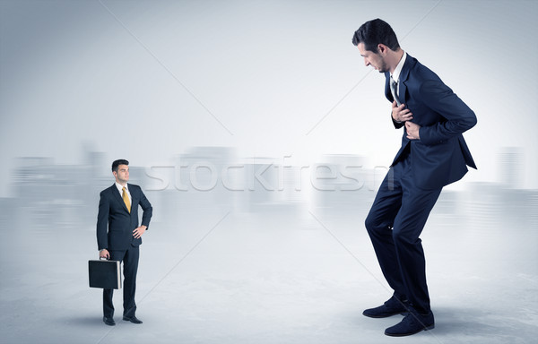 Stock photo: Giant businessman is  afraid of small executor