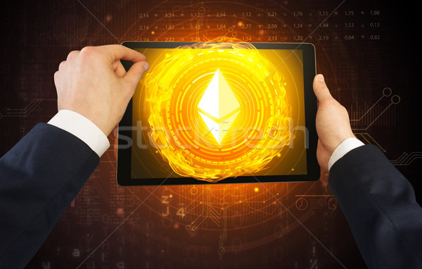 Hand using tablet with cryptocurrency concept Stock photo © ra2studio