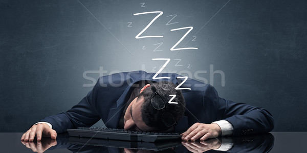 Businessman fell asleep at the office on his keyboard Stock photo © ra2studio