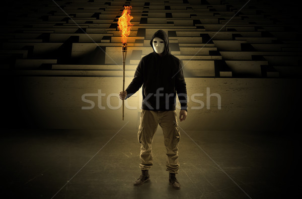 Man coming with burning flambeau from the maze concept Stock photo © ra2studio