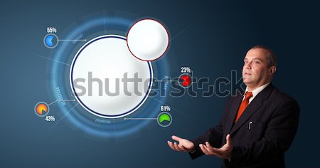 crazy businessman in suit holding a phone and presenting abstract modern pie chart Stock photo © ra2studio