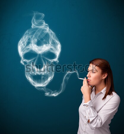Young woman smoking dangerous cigarette with toxic skull smoke  Stock photo © ra2studio