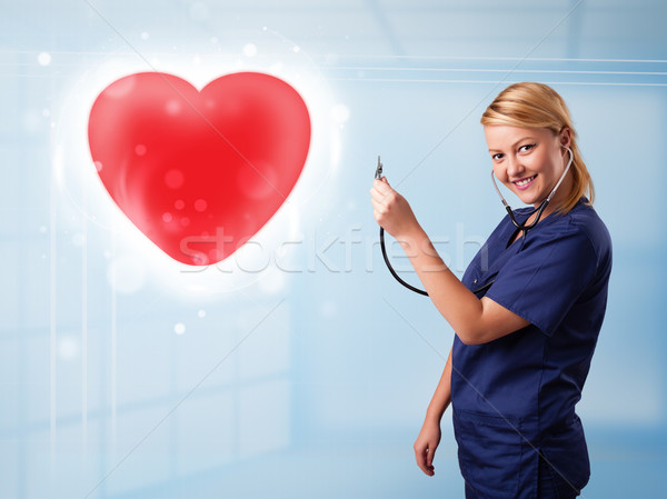 Jeunes infirmière guérison rouge coeur joli Photo stock © ra2studio
