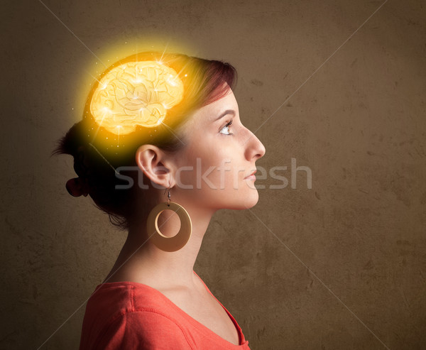 Young girl thinking with glowing brain illustration Stock photo © ra2studio