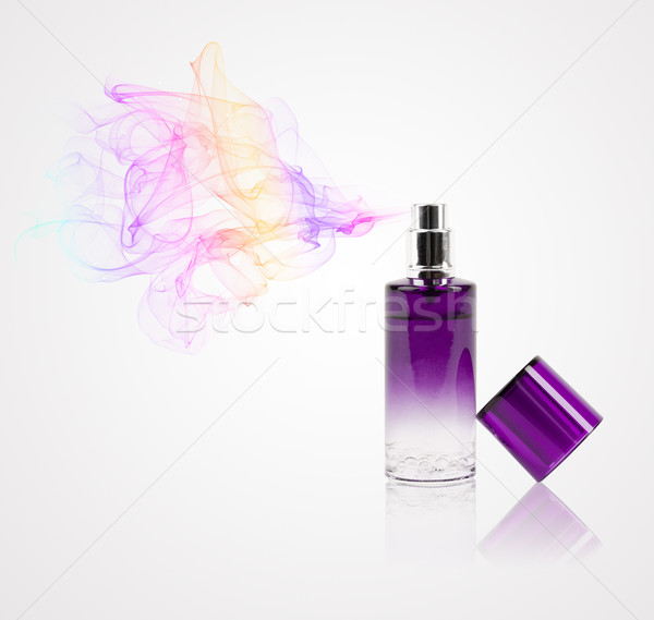 Perfume bottle spraying colored scent Stock photo © ra2studio