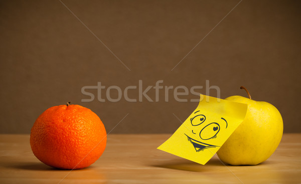 Apple with post-it note looking curiously at orange Stock photo © ra2studio