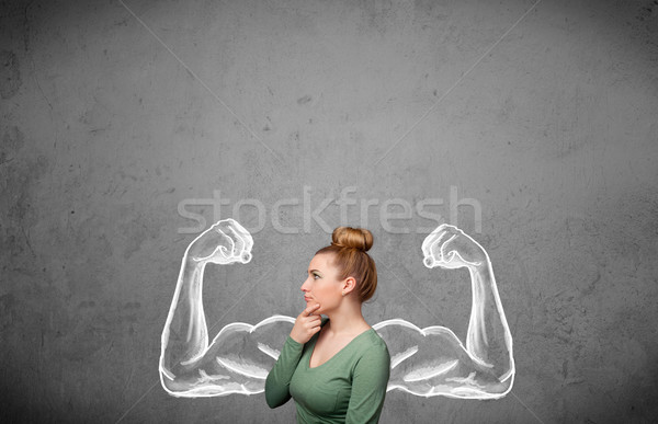 Stock photo: Young woman with strong muscled arms