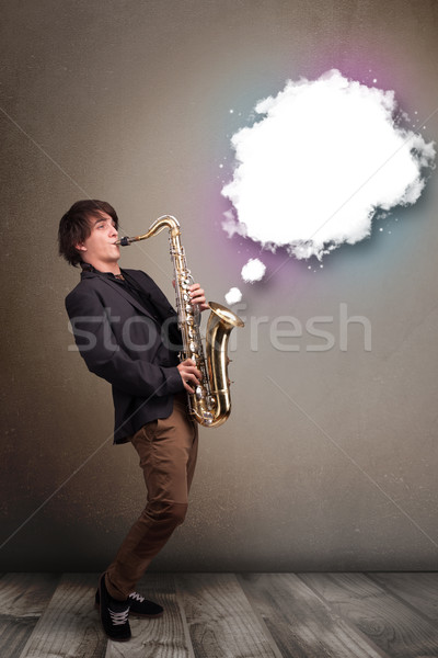 Young man playing on saxophone with copy space in white cloud Stock photo © ra2studio