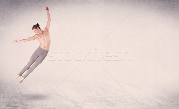 Modern ballet dancer performing art jump with empty background Stock photo © ra2studio