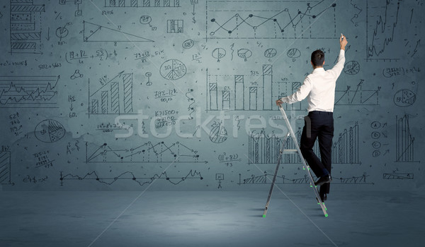 Man on ladder drawing charts Stock photo © ra2studio