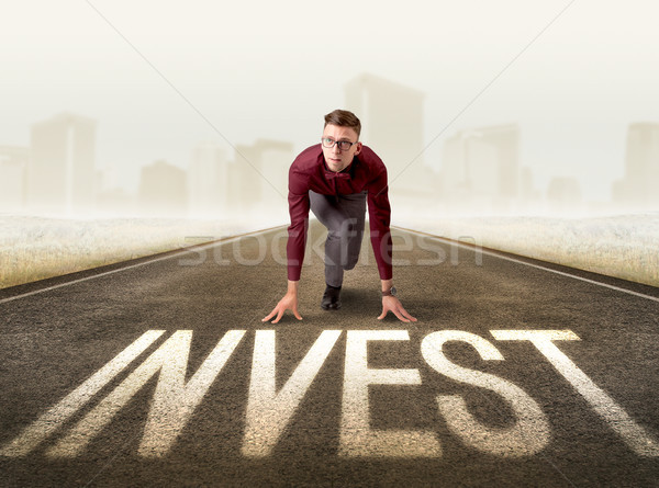 Businessman kneeling in ready position Stock photo © ra2studio