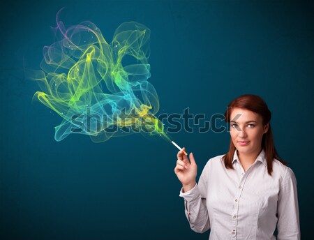 Bastante dama fumar cigarrillo colorido humo Foto stock © ra2studio