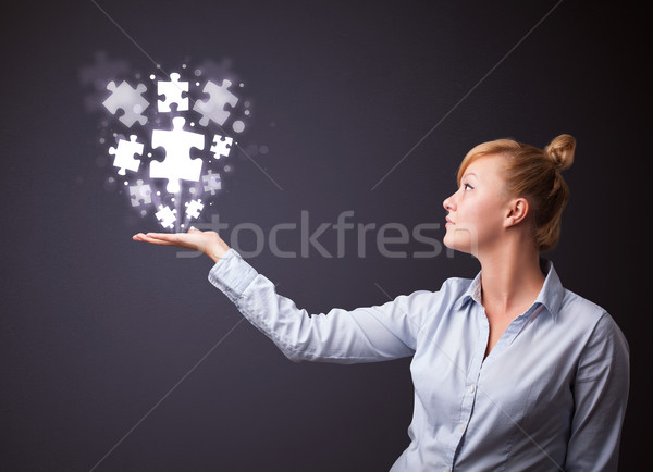 Puzzle pieces in the hand of a businesswoman Stock photo © ra2studio