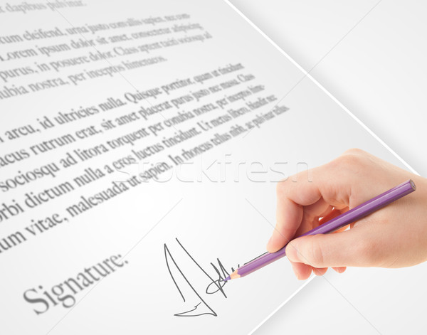 Hand writing personal signature on a paper form Stock photo © ra2studio