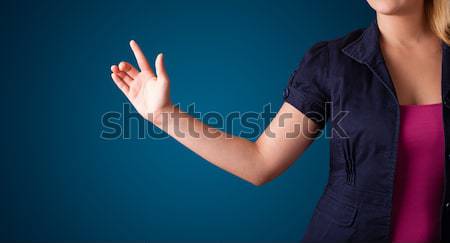 Woman pressing imaginary button Stock photo © ra2studio