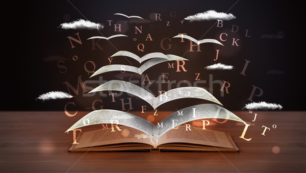 Pages and glowing letters flying out of a book  Stock photo © ra2studio