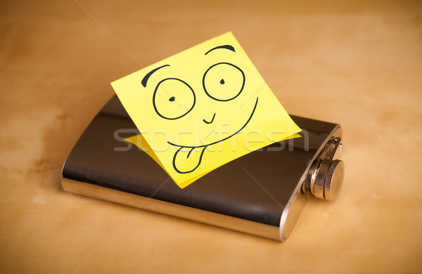 Post-it note with smiley face sticked on a hip flask Stock photo © ra2studio