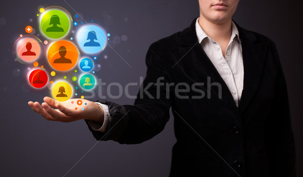 Social network icons in the hand of a businesswoman Stock photo © ra2studio