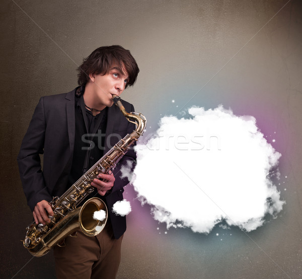 Young man playing on saxophone with copy space in white cloud Stock photo © ra2studio