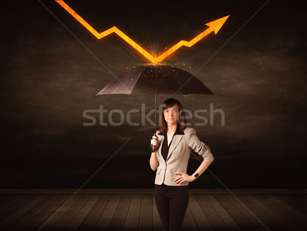 Businesswoman standing with umbrella keeping orange arrow  Stock photo © ra2studio