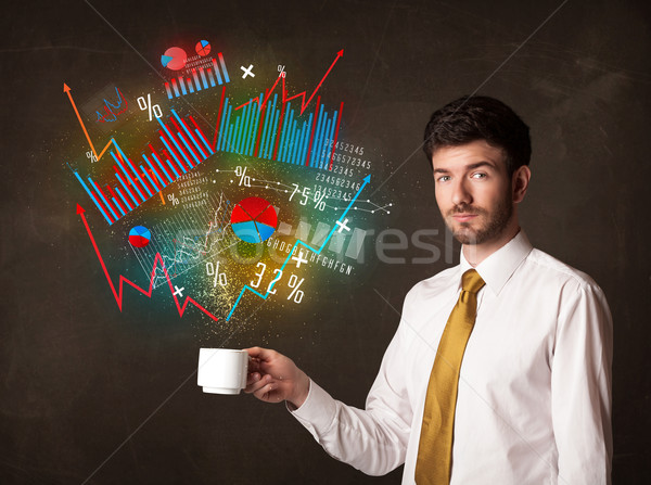 Businessman holding a white cup with diagrams and graphs Stock photo © ra2studio