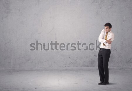 Young businessman standing confused Stock photo © ra2studio