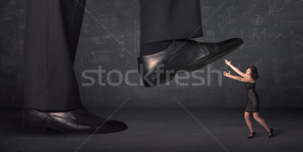 Huge leg stepping on a tiny businnesswoman concept Stock photo © ra2studio