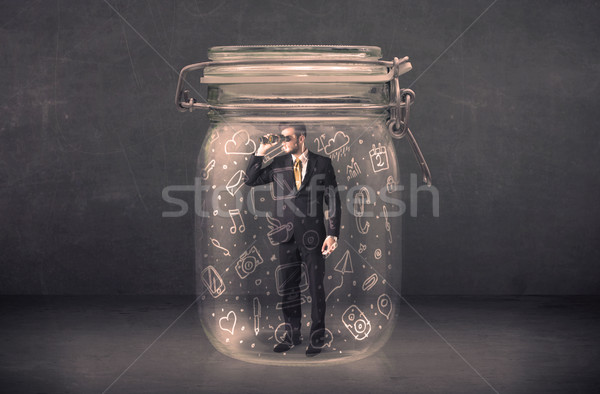 Business man captured in glass jar with hand drawn media icons c Stock photo © ra2studio