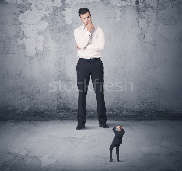 Big business bully looking at small coworker Stock photo © ra2studio