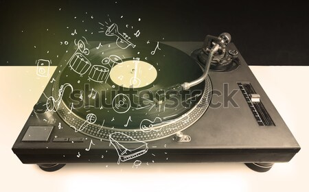 Stock photo: Turntable playing classical music with icon drawn instruments 
