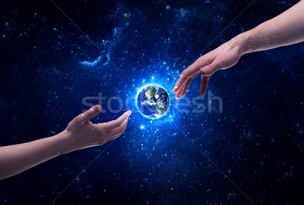 Hands in space touching planet earth Stock photo © ra2studio