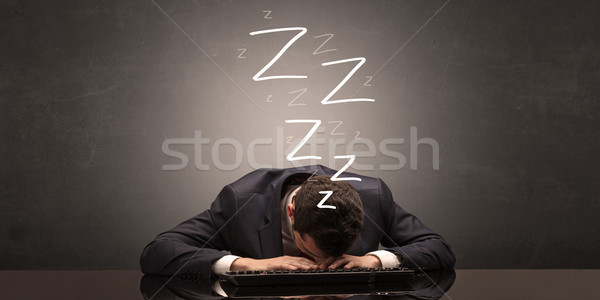 Businessman fell asleep at the office on his keyboard Stock photo © ra2studio