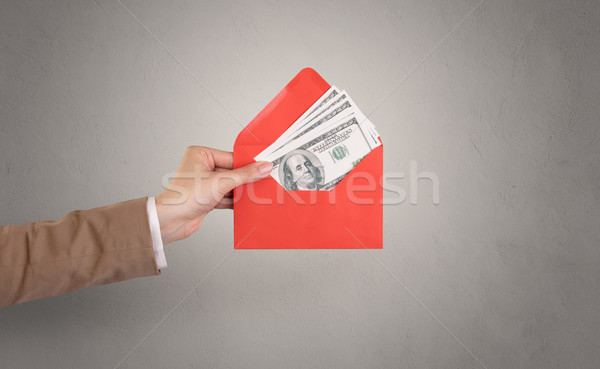 Hand holding envelope with empty wall background Stock photo © ra2studio