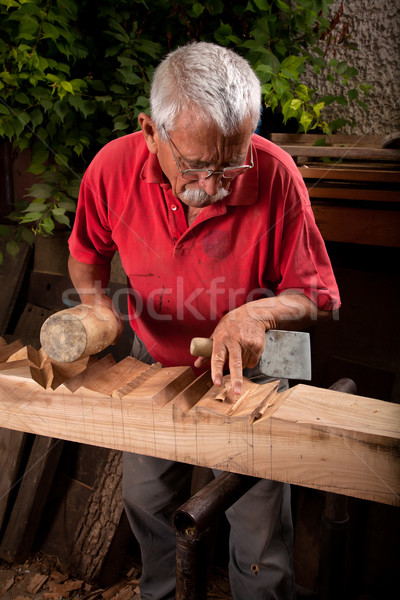 Old woodcarver working with mallet Stock photo © ra2studio