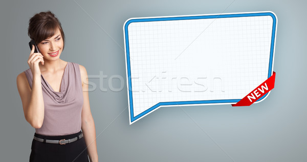 Beautiful young woman standing next to a modern speech bubble copy space and making phone call Stock photo © ra2studio