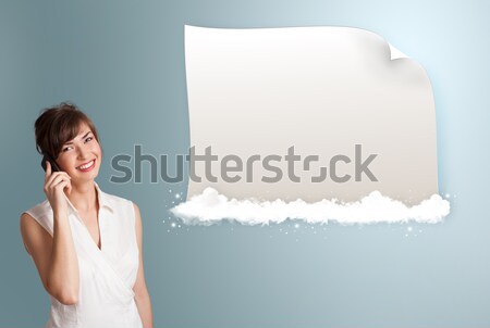 pretty young woman making phone call and presenting modern copy space on clouds Stock photo © ra2studio