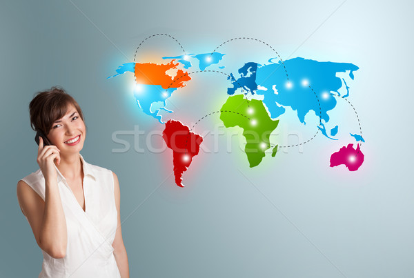 young woman making phone call with colorful world map Stock photo © ra2studio