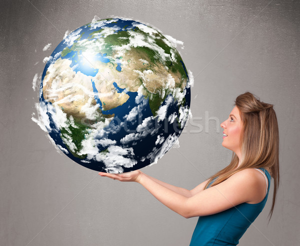 Stock photo: Pretty girl holding 3d planet earth
