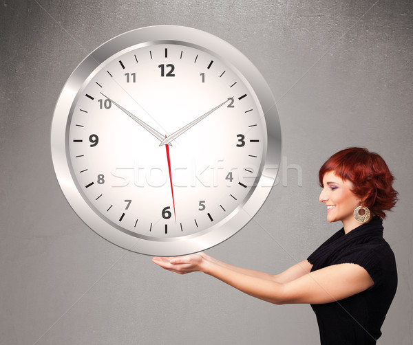 Attractive lady holding a huge clock Stock photo © ra2studio