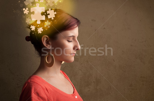 Stock photo: Young person thinking with glowing puzzle mind