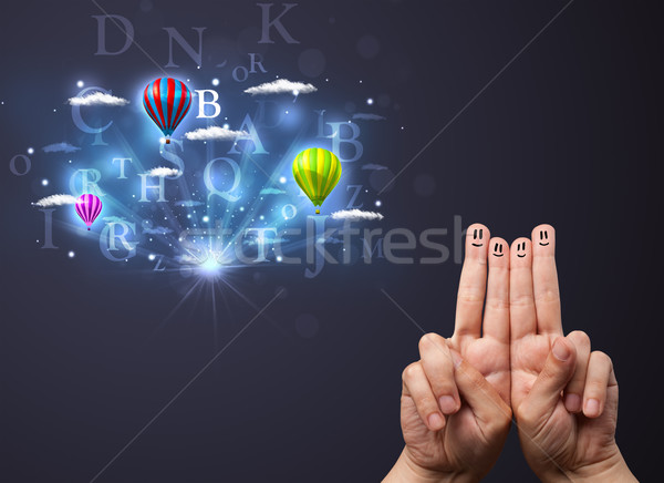 Happy cheerful smiley fingers looking at hot air balloons in the cloudy sky Stock photo © ra2studio