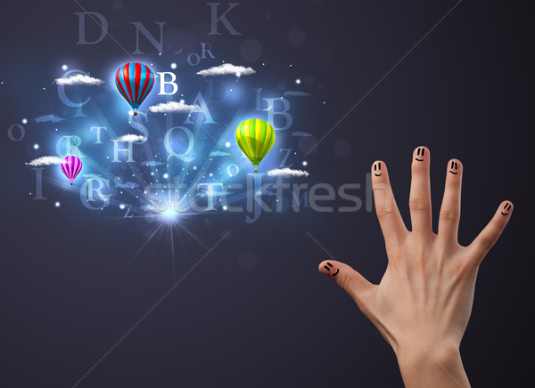 Happy cheerful smiley fingers looking at hot air balloons in the cloudy sky Stock photo © ra2studio