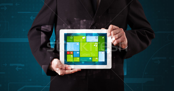 Fiatal üzletember tart tabletta modern szoftver Stock fotó © ra2studio