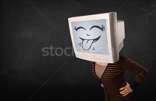Stock photo: Young girl wearing a monitor with a funny face