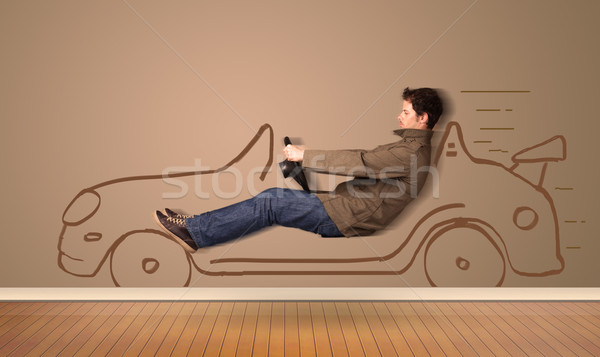 Happy man driving an hand drawn car on the wall Stock photo © ra2studio