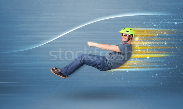 Young man driving in imaginary fast car with blurred lines  Stock photo © ra2studio