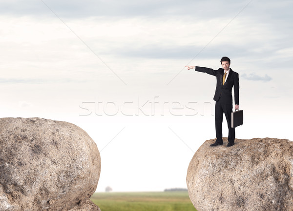 Businessman on rock mountain Stock photo © ra2studio
