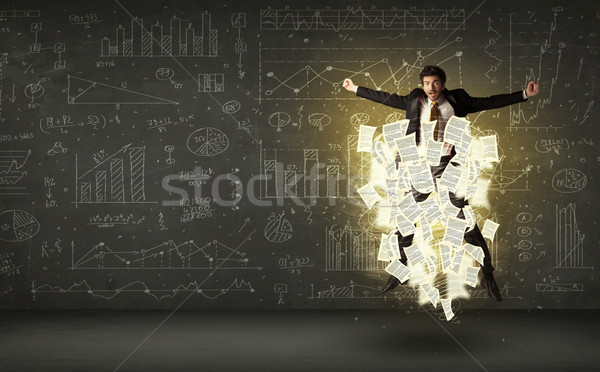 Stock photo: Handsome businessman jumping with paper document cloud