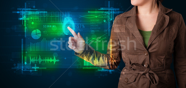 Young businesswoman pressing modern technology panel with finger Stock photo © ra2studio