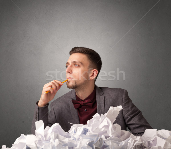 Businessman behind crumpled paper Stock photo © ra2studio